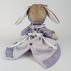 Burrowfolk rabbit, Fern, in her violet dress facing away from camera.  Showing the back detail and button fastening.