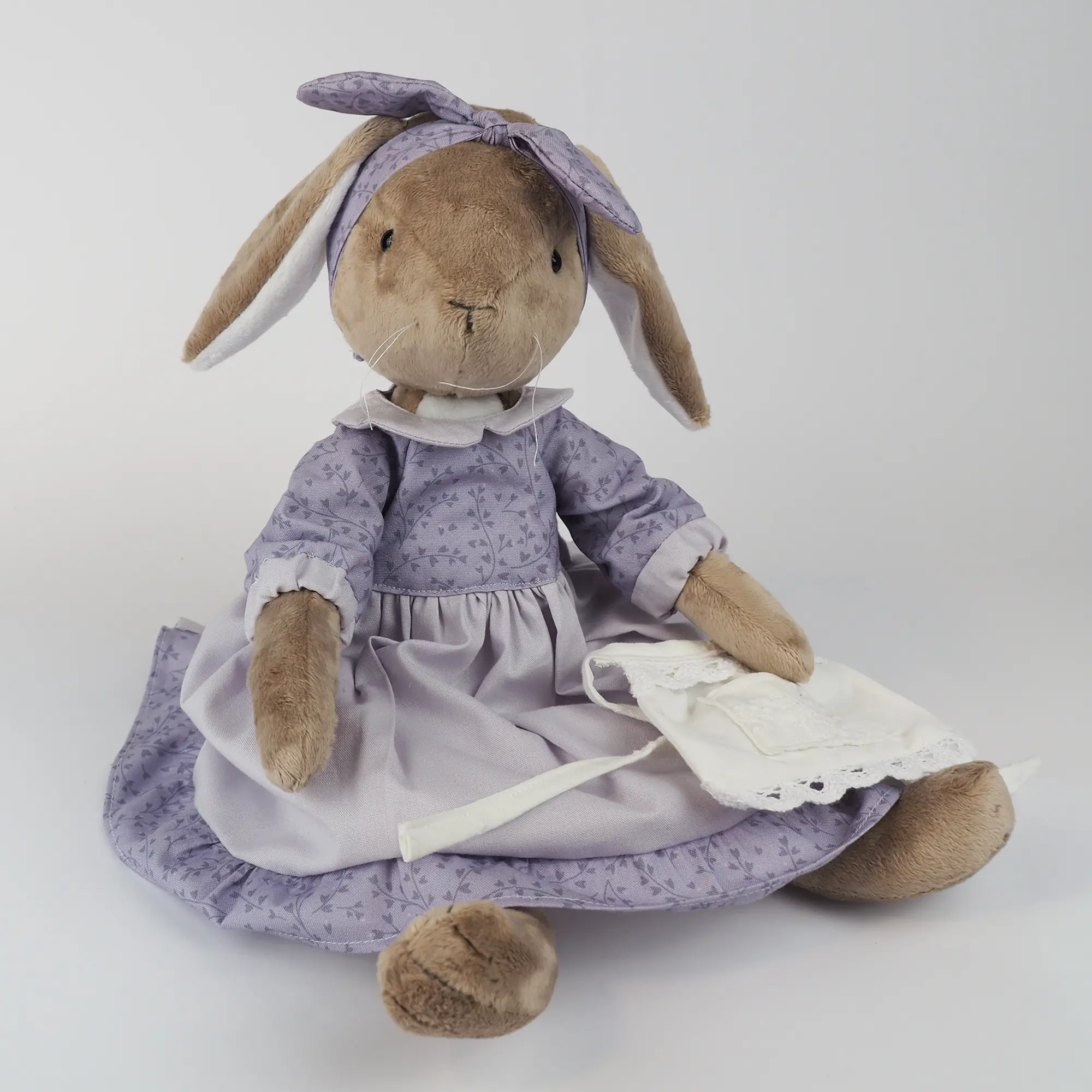 Burrowfolk rabbit, Fern, wearing her violet dress and holding her apron.