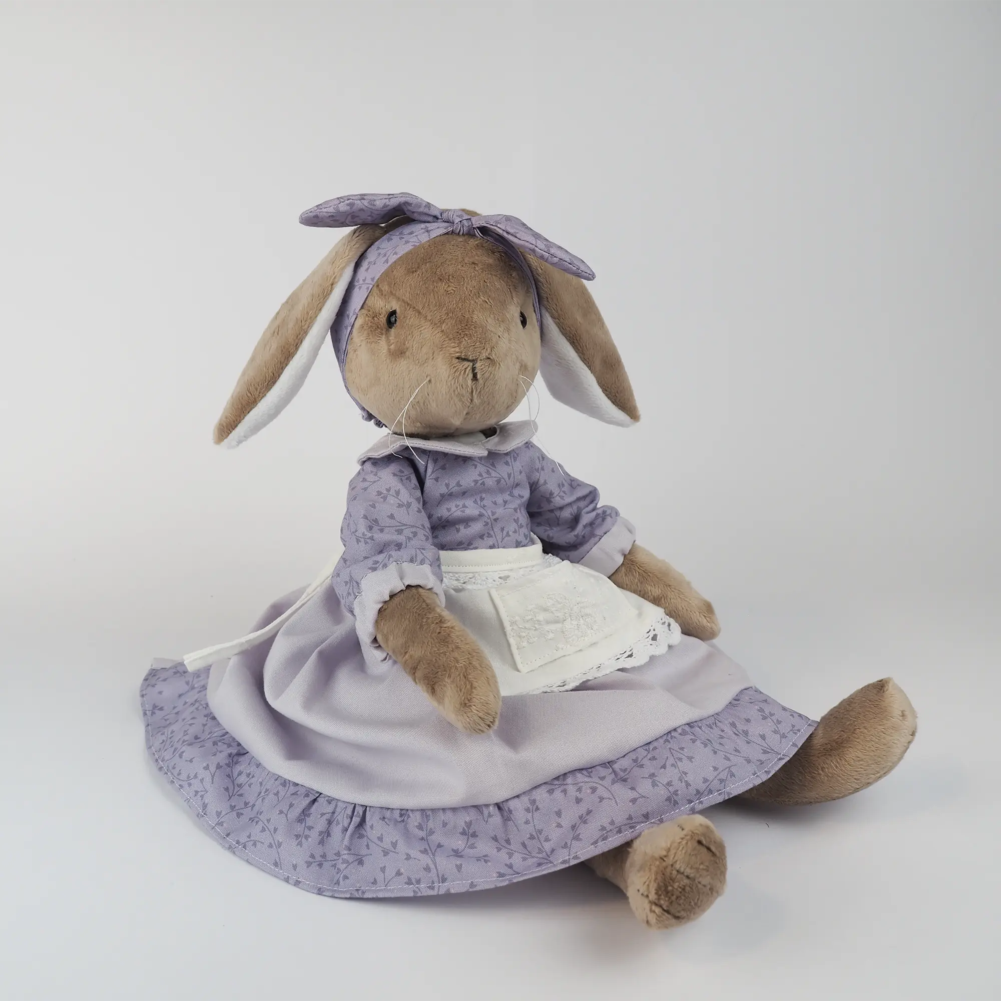 Burrowfolk rabbit, Fern, sitting in her violet dress and bow.