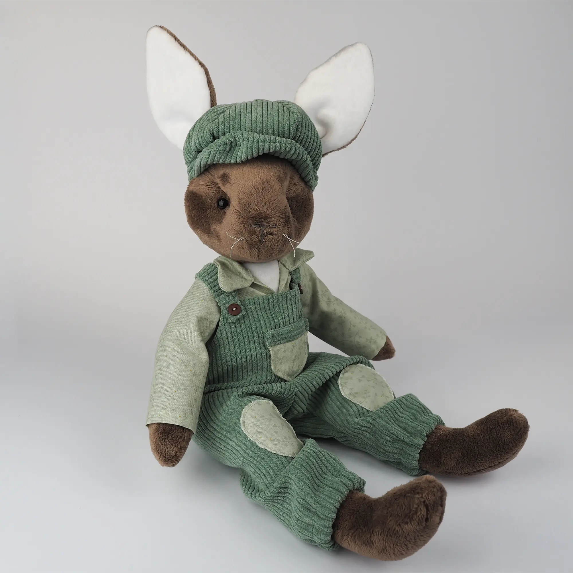 Burrowfolk rabbit, Freddie, sat in his green corduroy dungarees.